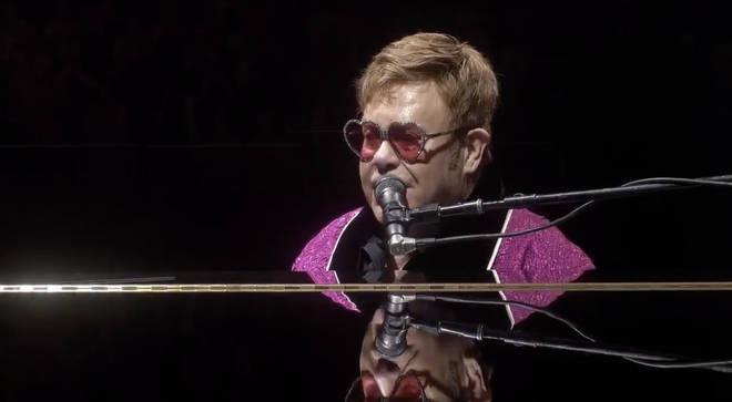 Elton addresses the audience whilst sat at the piano in Australia.
