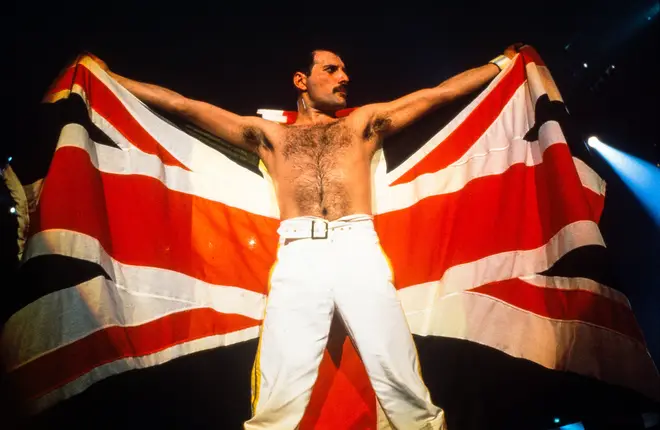 Freddie Mercury holding a union jack flag at the end of the August 9 concert