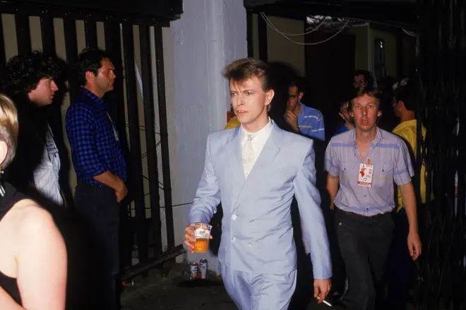 David Bowie hold a beer backstage at the Live Aid charity concert, Wembley Stadium, London, 13th July 1985.