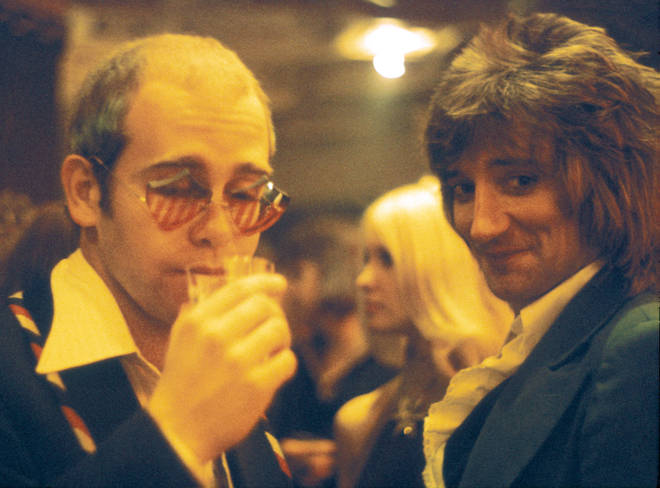 Elton John and Rod Stewart pictured backstage at a Ron Wood and Friends concert at Kilburn State Gaumont Theatre in London, 13th July 1974.