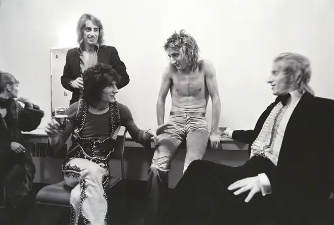 Rod Stewart and Faces pictured backstage with footballer Dennis Law in 1975.