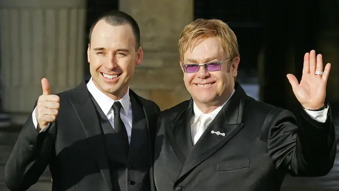 Sir Elton John (R) and his partner David Furnish pose for photographs at the Guildhall in Windsor, 21 December 2005, after conducting a short civil "wedding" ceremony at the registry office