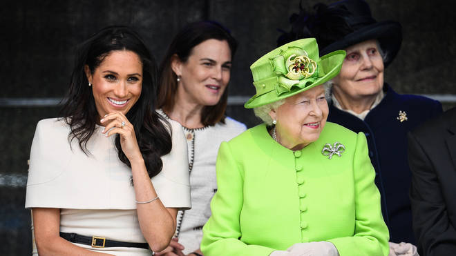 Samantha Cohen sitting behind Meghan Markle and the Queen