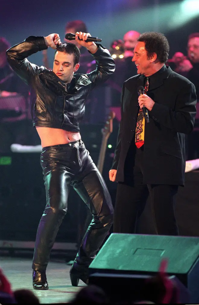 Robbie Williams and Tom Jones perform a medley of tracks from hit movie 'The Full Monty' at the Brit Awards on February 8, 1998