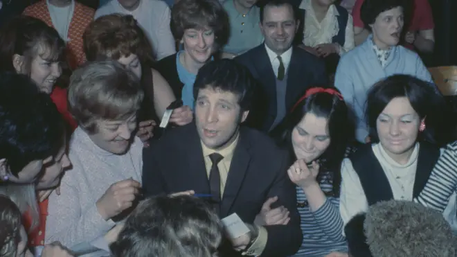 Tom Jones surrounded by female fans at a screening of TV show 'This Is Tom Jones' in 1969