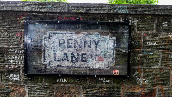 A protected sign on Penny Lane, signed by The Beatles' Paul McCartney, after graffiti was removed