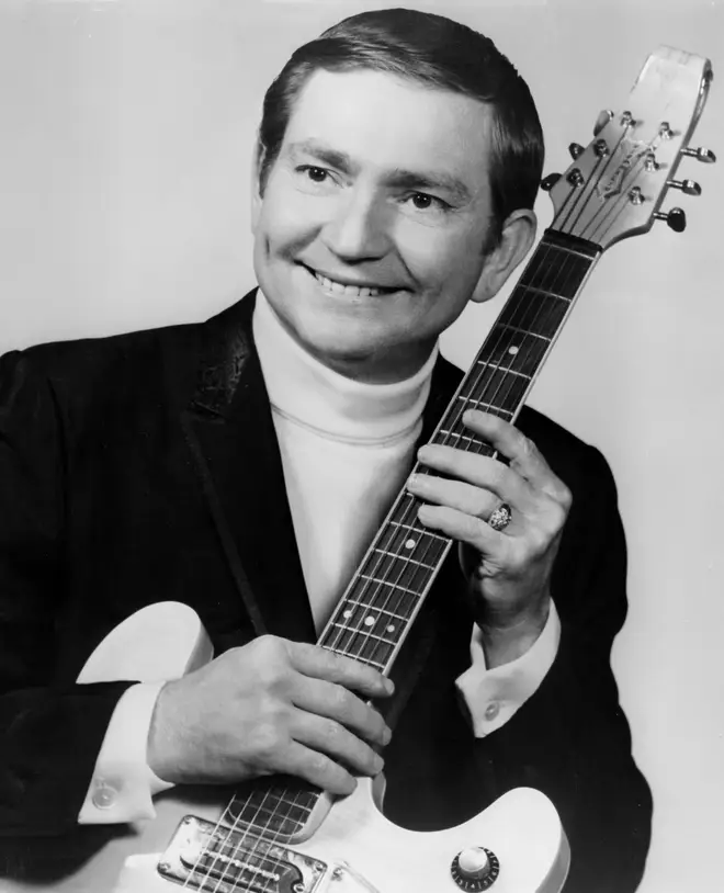 Willie Nelson poses for a portrait with an electric guitar in 1967