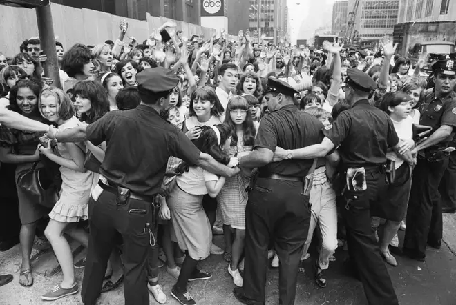 The performance came at the height of Beatlemania. Pictured, police hold back fans from crashing into the Warwick Hotel, the Beatles' New York residence