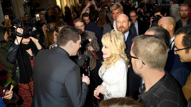Dolly Parton being interviewed on the red carpet in London