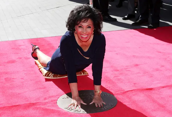 Dame Shirley Bassey places her hands into her handprints in a bronze plaque in Wembley Park's 'Square of Fame' at London's Wembley Arena in September 2019