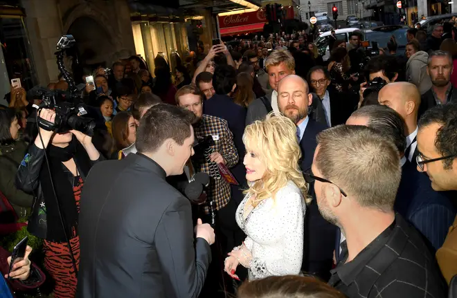 Dolly Parton being interviewed on the red carpet in London