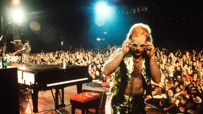"The energy I put into my performance, kicking out my piano stool and smashing my legs down on the piano, caught everyone off guard. It was pure rock ’n’ roll serendipity," Elton John said of his Troubadour gig. Pictured on stage circa 1974.