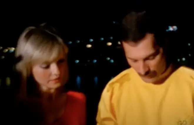 Freddie Mercury is seen attempting to sing a Hungarian folk while he continually turns to Mary Austin to check he is doing ok