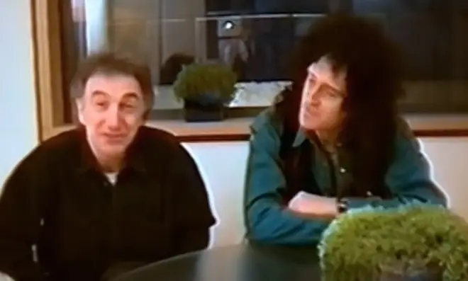 Queen's bassist can be seen sitting beside Brian May in the footage filmed in a recording studio in Chiswick, London.