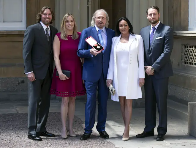 Barry Gibb, with his wife, Linda and children, Michael (right), Alexandra and Ashley (left) at Buckingham Palace, London, after he was knighted by the Prince of Wales during investitures at Buckingham Palace on June 26, 2018