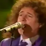 Freddie Mercury may have been the frontman of Queen, but it's Brian May's singing voice in a clip from 2003 that blows us away.