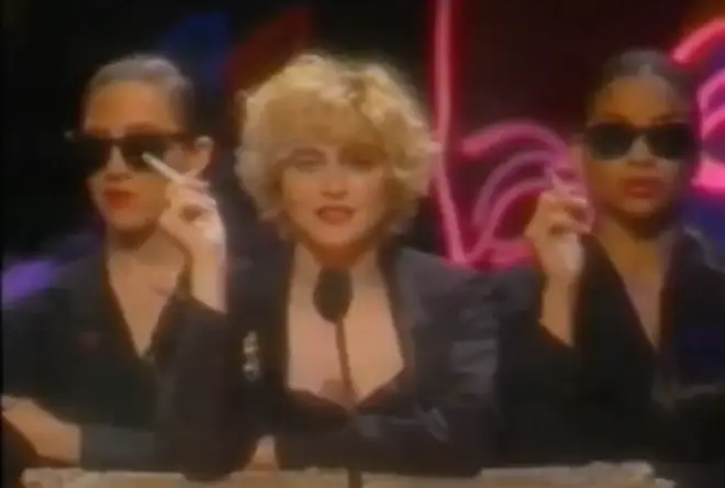 Madonna, smoking a cigarette and accompanied by two smoking backing dancers, comes on stage to present the Video Vanguard Award to "an artist who has made outstanding contributions to the world of music video.