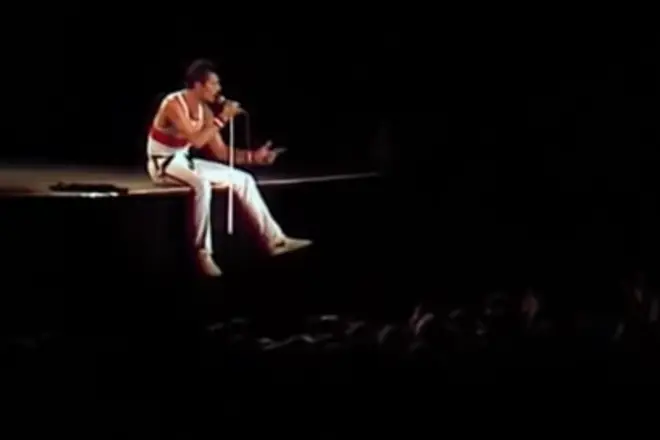 Freddie Mercury proclaimed to the crowd that he felt "positively knackered" and proceeded to sit on the edge of the stage