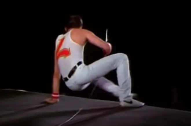 After getting down to sit on the side of the stage, Freddie Mercury started speaking to the delighted crowd.