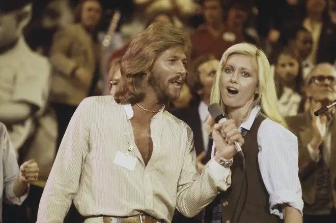 Performing at the Music for UNICEF Concert in New York, Olivia joined the Bee Gees, ABBA and Rod Stewart for a medley of 'Put A Little Bit Of Love In Your Heart' in 1979. (Pictured with Barry Gibb)