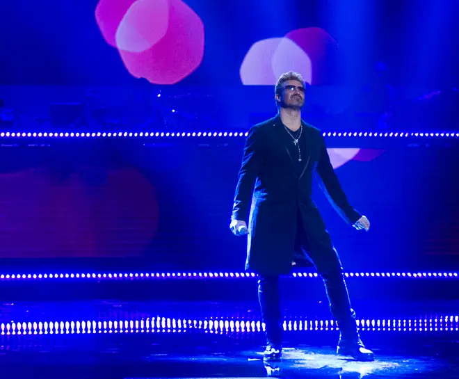 Rob Lamberti performs on stage as George Michael