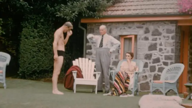 The Queen and Prince Philip talk by the pool at the home of at the home of New Zealand's Governor-General, Sir Willoughby Norrie