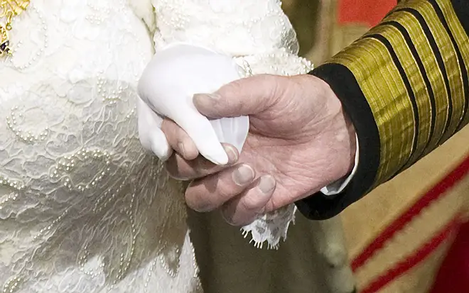 Prince Philip holds the hand of his wife Queen Elizabeth as they attend the State Opening of Parliament on December 3, 2008.