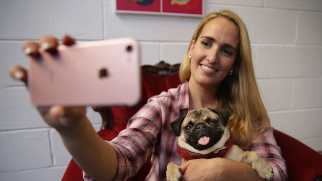 Woman taking a selfie with a dog