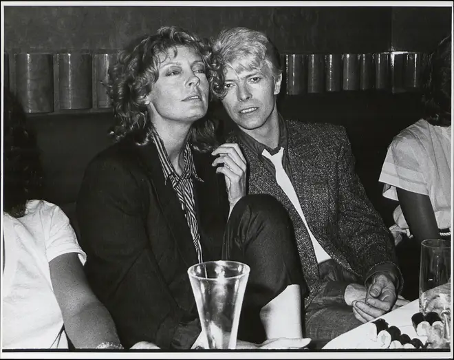 David Bowie at a party with actress Susan Sarandon, circa 1983.