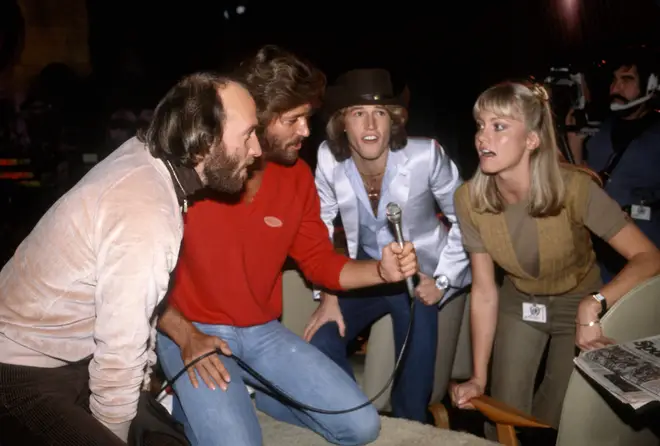 Bee Gee brothers (L to R) Maurice Gibb, Barry Gibb, Andy Gibb and Olivia Newton-John practising harmonies, circa 1980 in New York City.