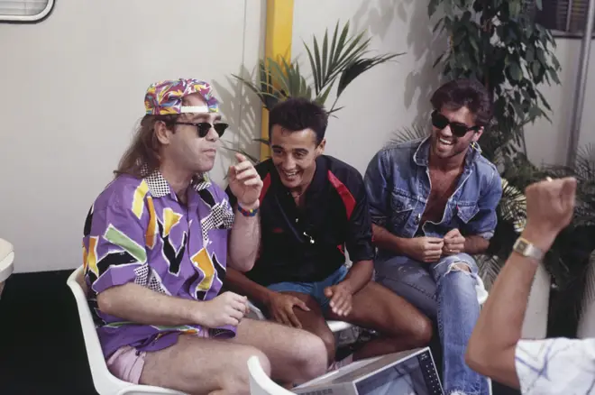 Andrew Ridgeley and George Michael (right) of Wham! with Elton John (left) backstage prior to performing at their farewell concert, entitled 'The Final' at Wembley Stadium in London on 28th June 1986.