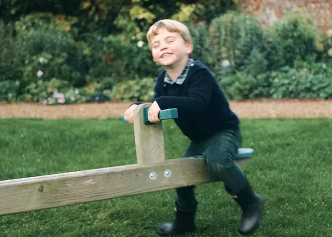 Prince Louis laughs as he plays on a seesaw with his sister Princess Charlotte, in the garden of the Duke and Duchess of Cambridge's Norfolk home, Anmer Hall.
