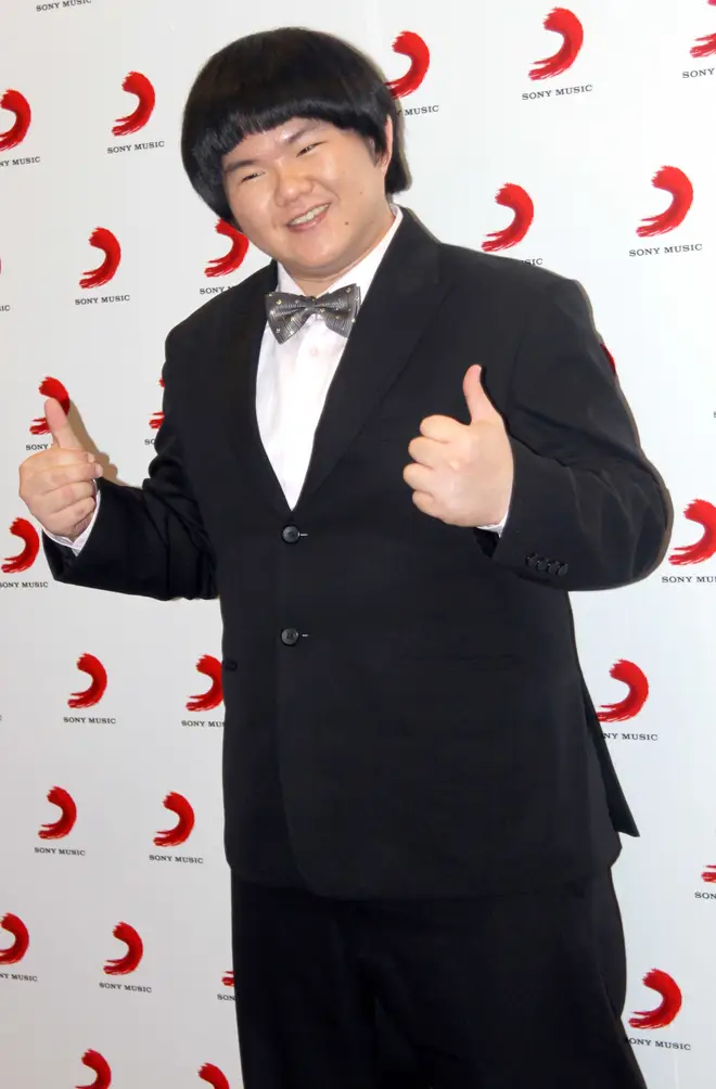 Lin Yu Chun, nicknamed Taiwan's Susan Boyle, poses for photos during the signing ceremony with Sony Music on May 13, 2010 in Shanghai, China.