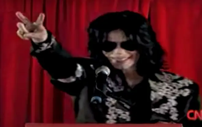 Introduced by presenter Dermot O'Leary, Michael Jackson then stepped up to the podium to the delight of screaming fans, his long dark hair and black aviator sunglasses obscuring his face.