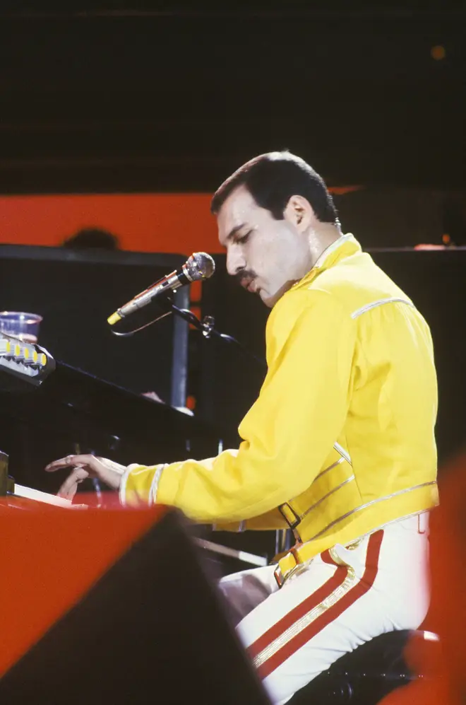 Freddie Mercury of Queen playing piano while performing on stage on the Magic Tour at Wembley Stadium, London, July 1986. (Photo by Suzie Gibbons/Redferns)