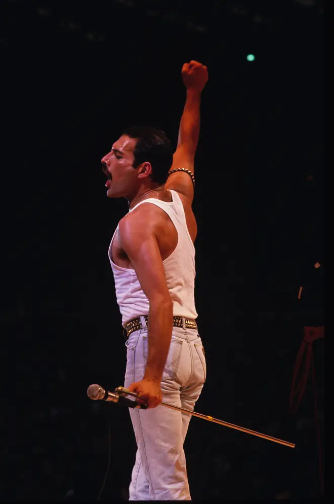 Freddie commanding the 80,000 strong crowd at Wembley Stadium during their Live Aid set.