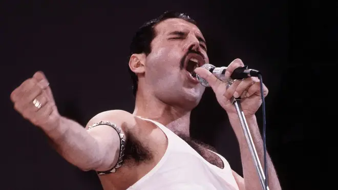 Freddie Mercury of Queen performs on stage at Live Aid at Wembley Stadium, 1985. (Photo by Phil Dent/Redferns)