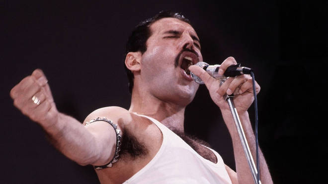 Freddie Mercury of Queen performs on stage at Live Aid at Wembley Stadium, 1985. (Photo by Phil Dent/Redferns)