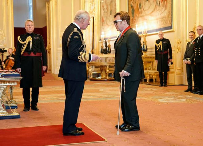 Prince Charles awarded Sir Elton John for his services to both music and charity.