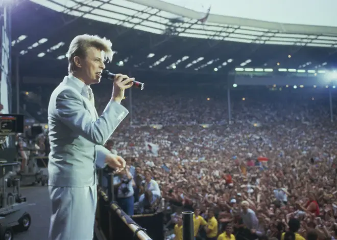 David Bowie performing at the Wembley Stadium in 1985 for Live Aid. (Photo by Georges De Keerle/Getty Images)