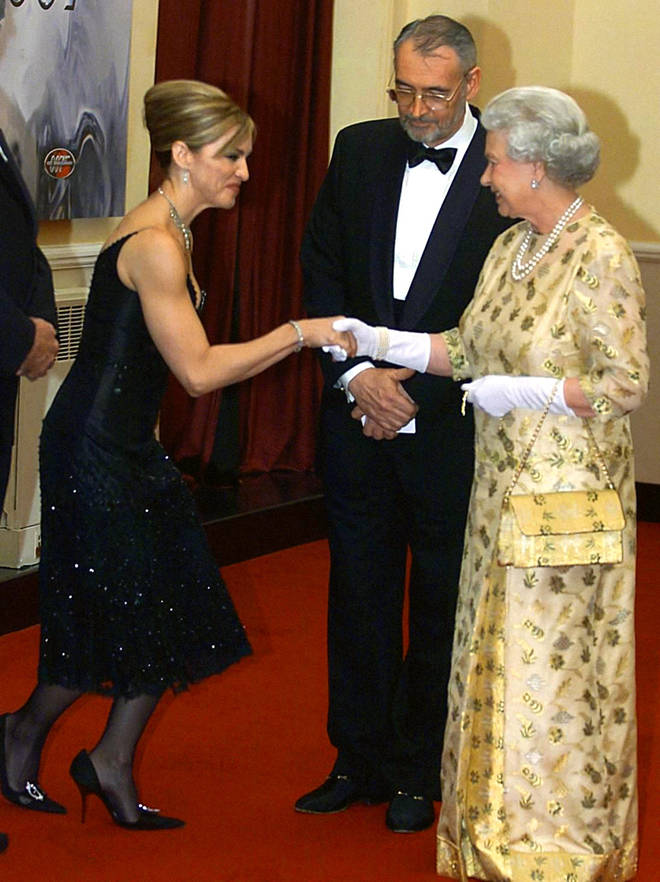 Madonna curtsies as she meets The Queen in 2002.