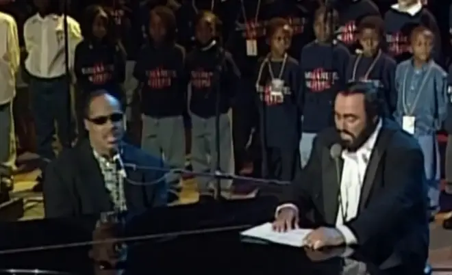 Stevie Wonder and Pavarotti sing the newly-penned song 'Peace Wanted Just To Be Free' to the stunned audience in a moment that will go down forever in musical history.