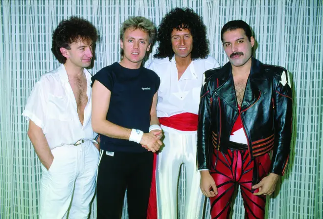 Speaking to RockFM in Spain, Brian May opened up about the likelihood of John Deacon returning to Queen and his and Roger Taylor's efforts to lure him back. (Pictured in 1985, L to R: John Deacon, Roger Taylor, Brian May, Freddie Mercury)