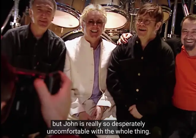 &squot;John is so desperately uncomfortable with the whole thing," Brian May says in the clip. (Pictured L to R: John Deacon, Roger Taylor and Elton John).