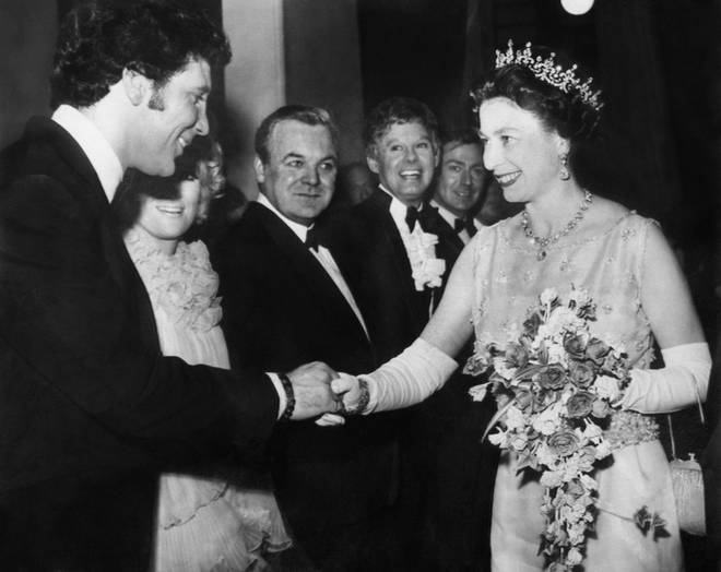 Her Majesty Queen Elizabeth II was on the throne for some of the greatest moments in music history. Pictured, meeting Tom Jones in 1972.