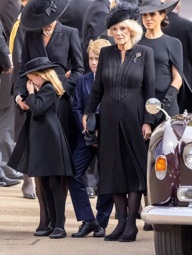 Princess Charlotte cries next to her mother Catherine, alongside Camilla, George and Meghan