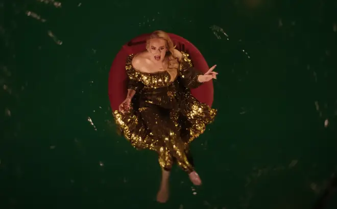 As the footage unfolds, the singer can be seen decked in a sequinned gold gown with a glass of wine in one hand and a bottle in the other, as she's joined by synchronised swimmers and a potential love interest.