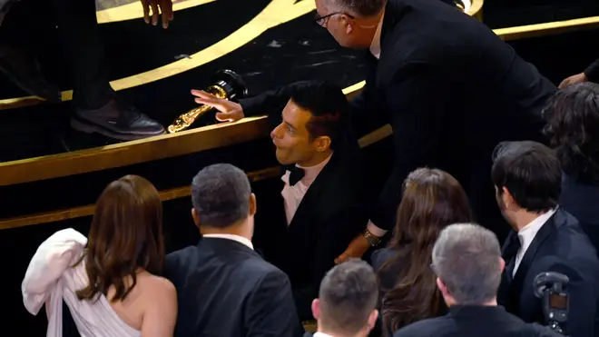 Rami Malek takes a tumble at the Oscars