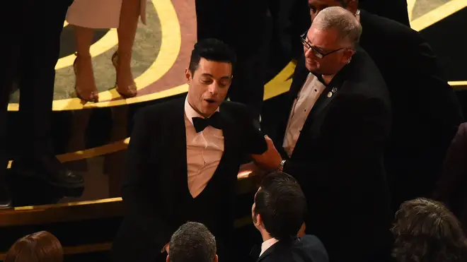 Rami Malek laughs off his on-stage fall at the Oscars