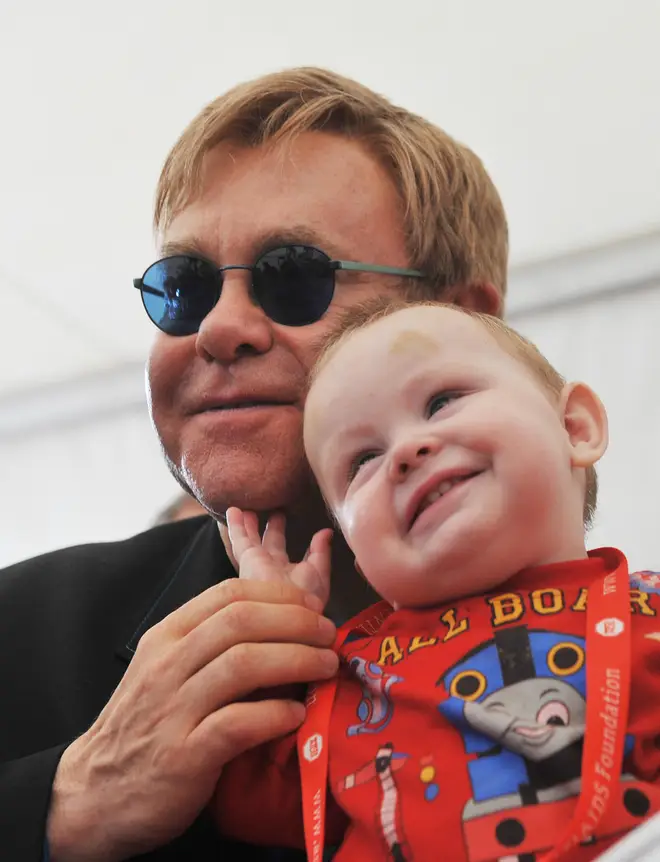 Elton John pictured with orphan Lev in 2009